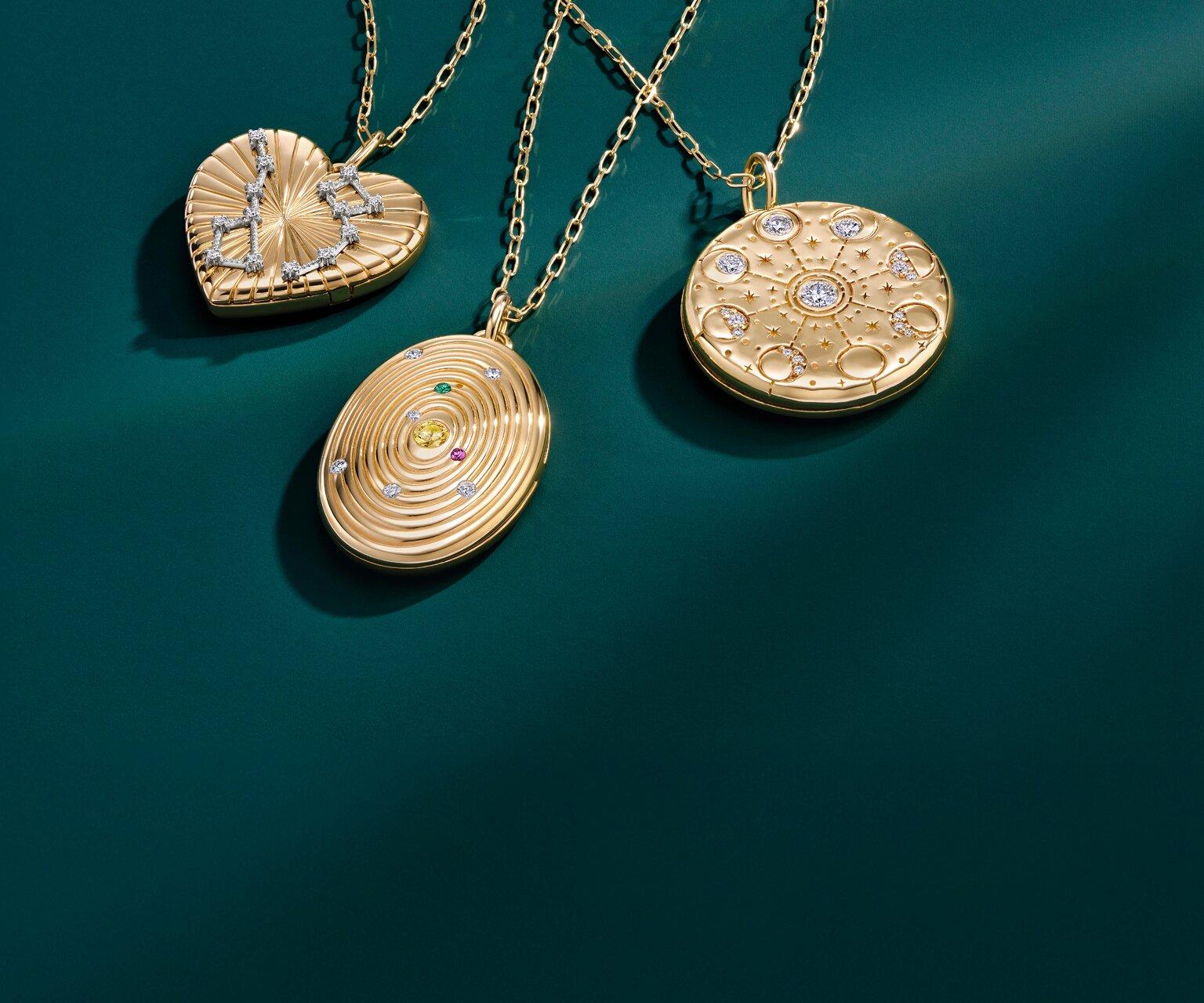 Assortment of gold pendant necklaces perfect for Mother's Day gifting.