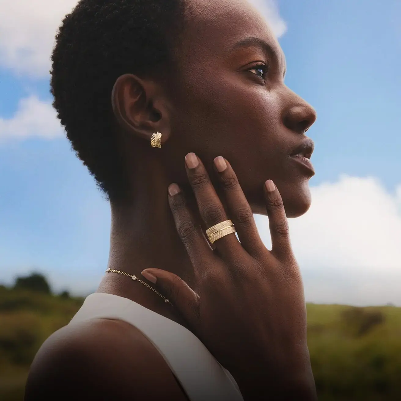 Model wearing gold and diamond fine jewelry from the Jane Goodall collection.