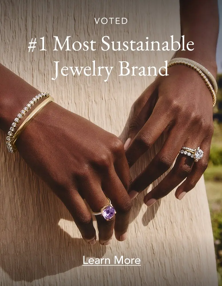 Model wearing assortment of diamond and gemstone fine jewelry.