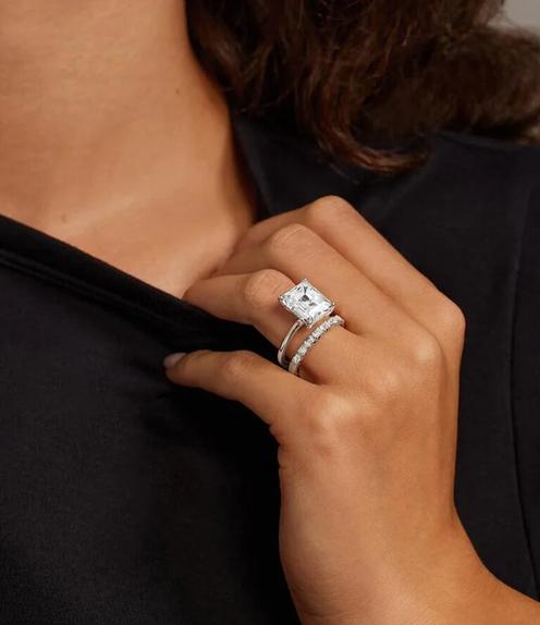 Model wearing a women's diamond wedding ring.