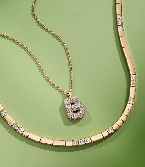 Diamond and gold personalized necklaces.